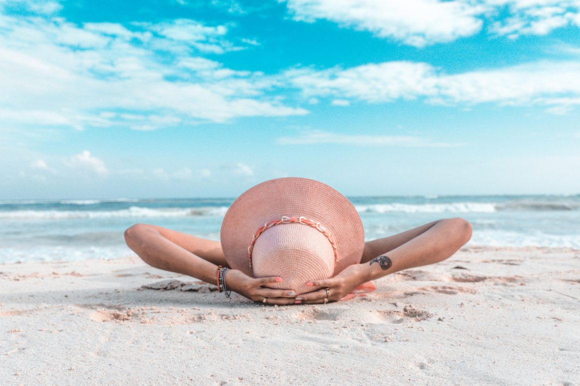 How to Plan for Retirement At Every Stage Of Your Life: A Woman lying down on the beach